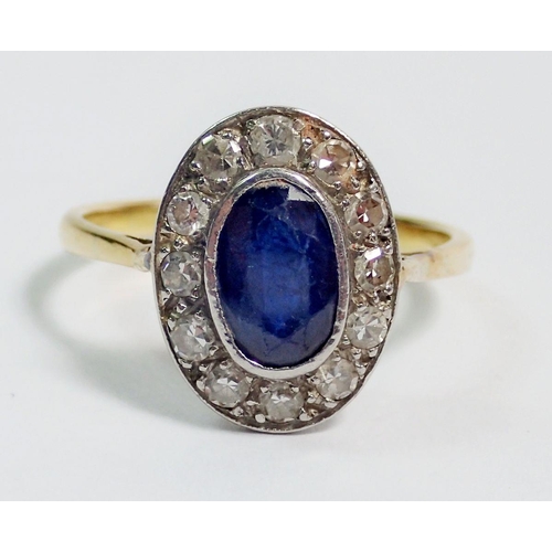 396 - An 18 carat gold sapphire and diamond oval cluster ring, 1.5 x 1.1cm, size P, 3.9g