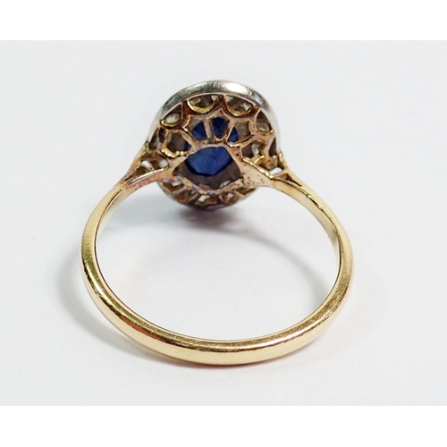 396 - An 18 carat gold sapphire and diamond oval cluster ring, 1.5 x 1.1cm, size P, 3.9g