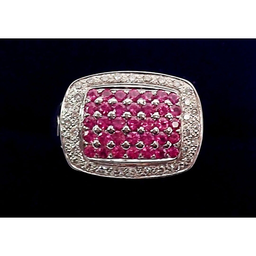 406 - An 18 carat white gold ring set panel of pink stones within diamond surround, size M to N, 11g