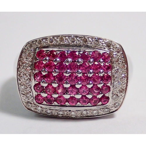 406 - An 18 carat white gold ring set panel of pink stones within diamond surround, size M to N, 11g