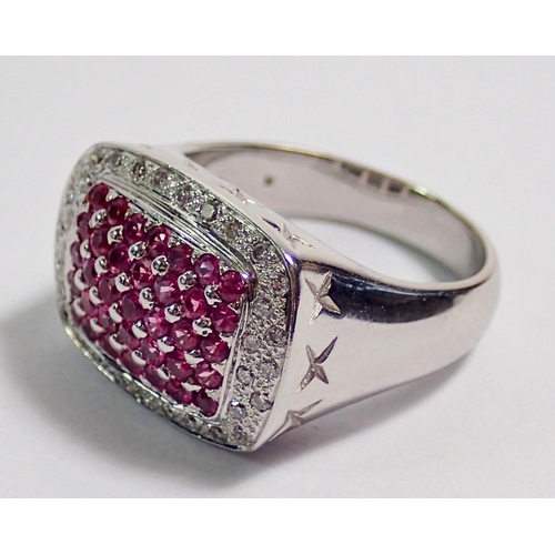 406 - An 18 carat white gold ring set panel of pink stones within diamond surround, size M to N, 11g