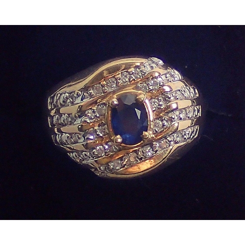 408 - A 10 carat gold ring set oval cut sapphire within diamond diagonal set surround, size W, 6g