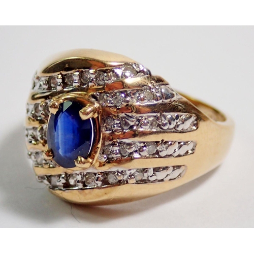 408 - A 10 carat gold ring set oval cut sapphire within diamond diagonal set surround, size W, 6g