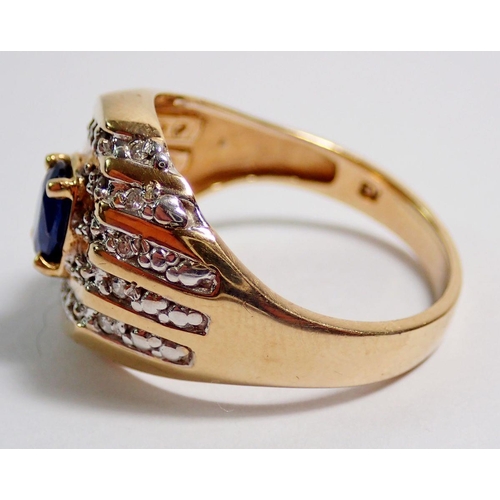 408 - A 10 carat gold ring set oval cut sapphire within diamond diagonal set surround, size W, 6g