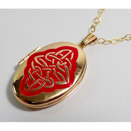 416 - A 9 carat gold locket with red knot design to front on 9 carat gold chain, 4.2g