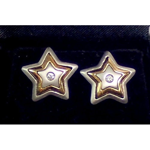 429 - A pair of 18 carat white and yellow gold star form earrings set diamonds, 4.2g, 1cm diameter