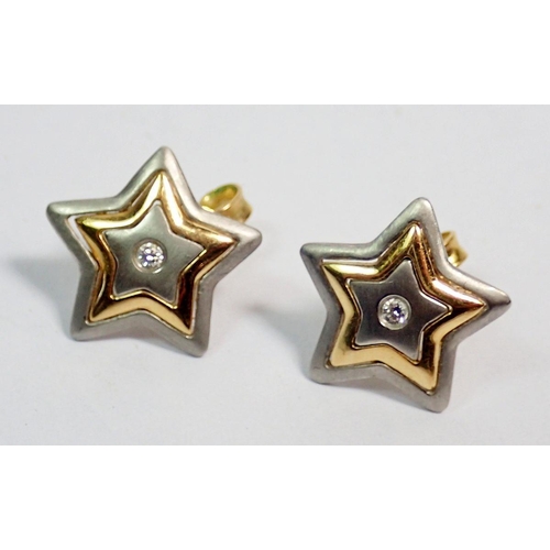 429 - A pair of 18 carat white and yellow gold star form earrings set diamonds, 4.2g, 1cm diameter