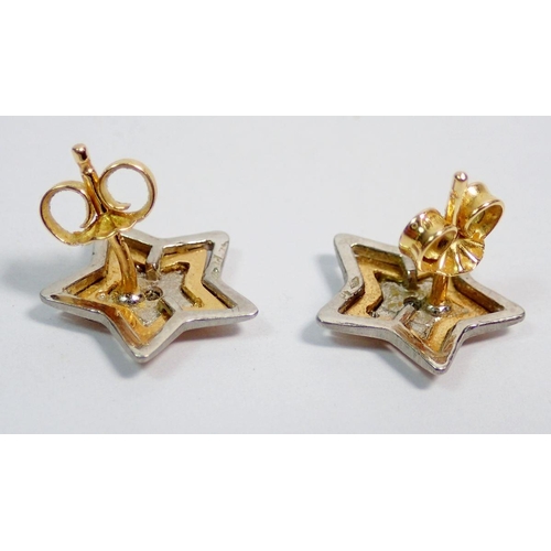 429 - A pair of 18 carat white and yellow gold star form earrings set diamonds, 4.2g, 1cm diameter