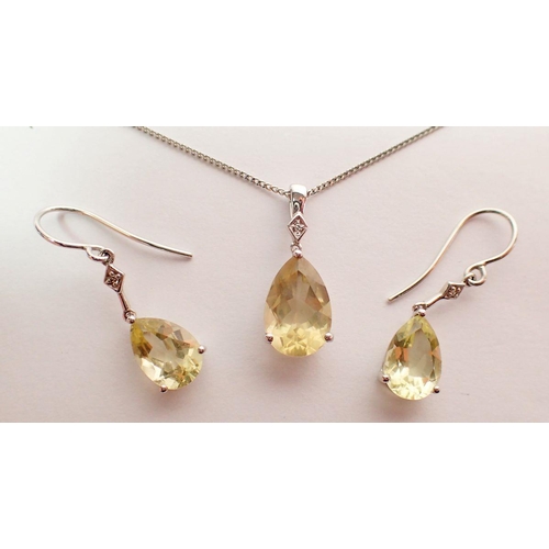 430 - A pair of 9 carat white gold earrings set citrines and chip diamonds and matching pendant necklace, ... 