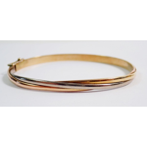 433 - A 14ct gold two colour bangle 9.7g and three triple yellow metal bangles 10g