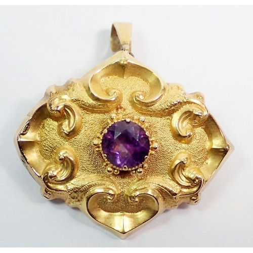 445 - A gold embossed pendant brooch inset amethyst and decorated scrolls, unmarked but tested as gold, 5.... 