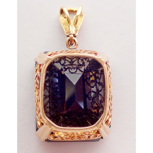 446 - A large smokey quartz (2.2 x 1.8cm) pendant in yellow metal mount - unmarked but tested as 18 carat ... 