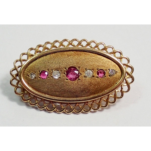 450 - A 9 carat gold oval brooch set rubies and diamonds, 3.2 x 1.8cm, 5.3g