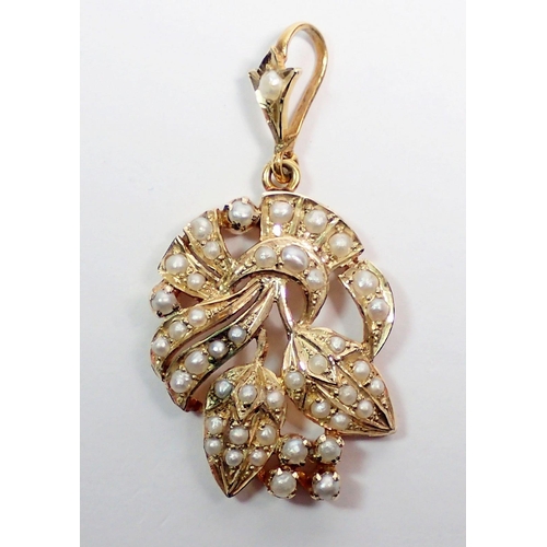 460 - An Edwardian gold and seed pearl pendant in the form of a floral spray, 5cm drop, 6.4g