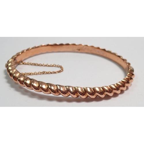 461 - A 9 carat rose gold spiral bangle, boxed, 7.2g