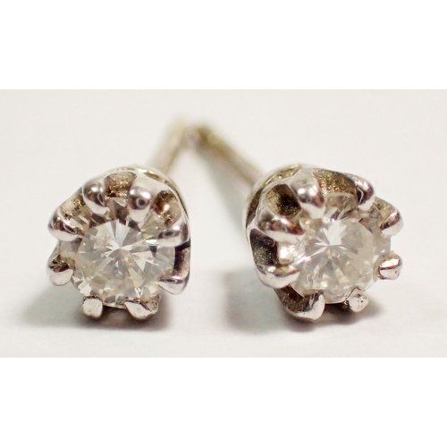 463 - A pair of 9 carat white gold diamond stud earrings