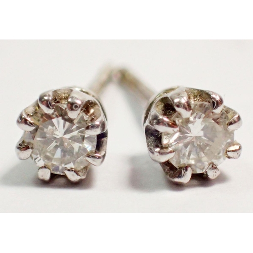 463 - A pair of 9 carat white gold diamond stud earrings