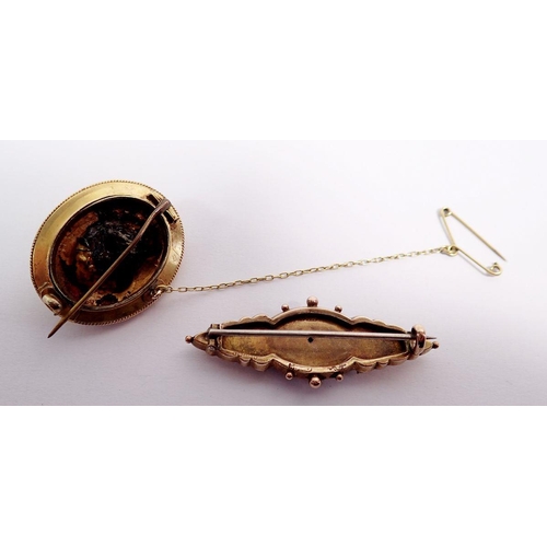 476 - A Victorian 9 carat gold brooch set chip diamond, 4.5cm, 3.6g and an oval yellow metal brooch, 4.7g