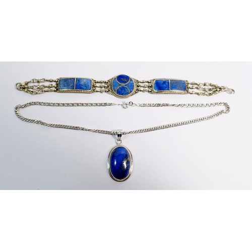 488 - A silver lapis lazuli pendant and an Eastern white metal and lapis lazuli bracelet