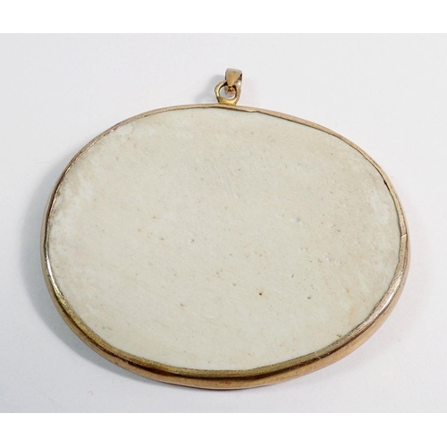 490 - A Chinese antique porcelain fragment in yellow metal surround mounted on a pendant, 6 x 5cm