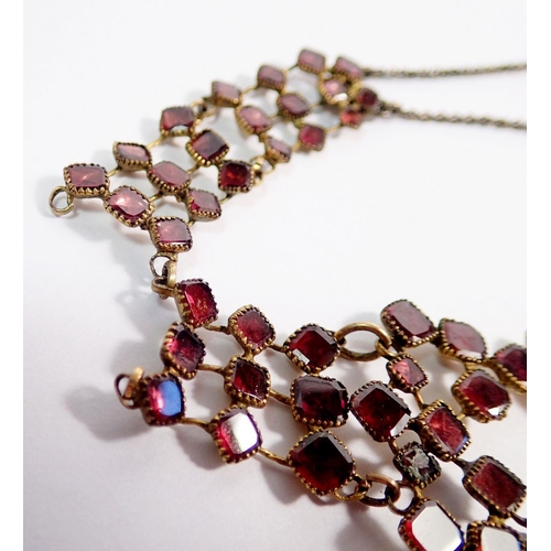 491 - An antique garnet set gilt metal necklace - some repair needed