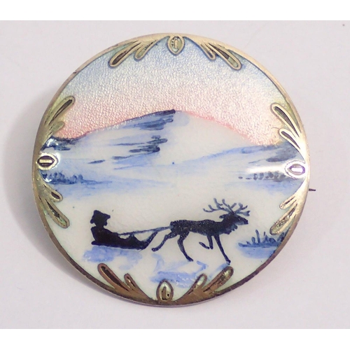 495 - A Norwegian silver and enamel circular brooch decorated reindeer and sled scene, 3.7cm diameter