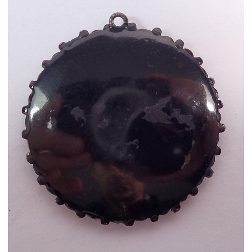 506 - A Victorian jet circular open locket pendant, 4.3cm diameter