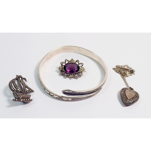 510 - A silver and amethyst brooch, white metal nielo bangle, silver locket and silver marcasite brooch