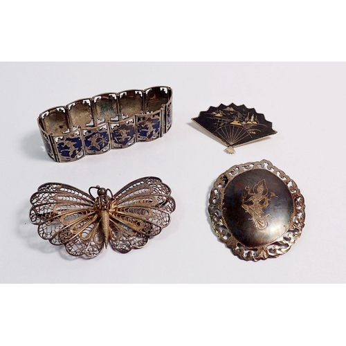 517 - A silver niello bracelet and brooch plus two white metal brooches