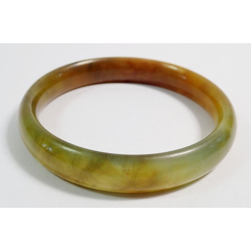 519 - A Chinese jade bangle, 7cm diameter and a jade pendant with carved rat on organic leaf decoration, 4... 