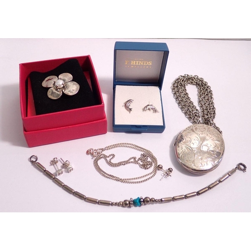 546 - A silver Pia flower form brooch and a large oval silver engraved locket plus other silver jewellery