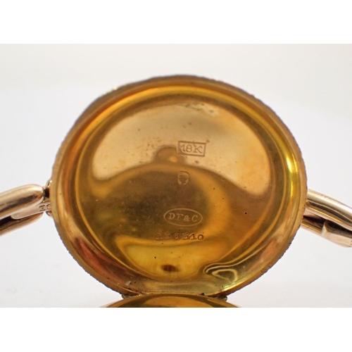 599 - An 18 carat gold early 20th century ladies wrist watch with all over engraved decoration, 3.2cm diam... 