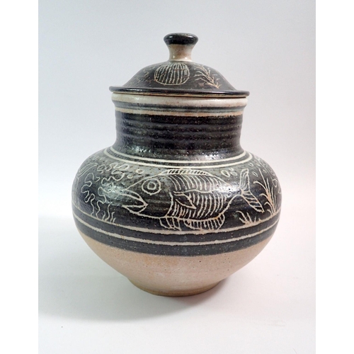 72 - A studio pottery jar and cover decorated fish with impressed mark, 26cm