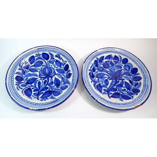 85 - A pair of continental blue and white tin glazed plates, 34.5cm diameter