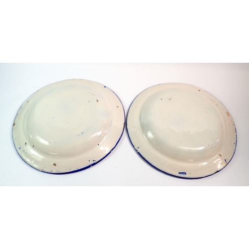 85 - A pair of continental blue and white tin glazed plates, 34.5cm diameter