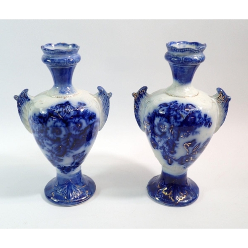 89 - A pair of Victorian blue and white two handled vases, 24cm tall