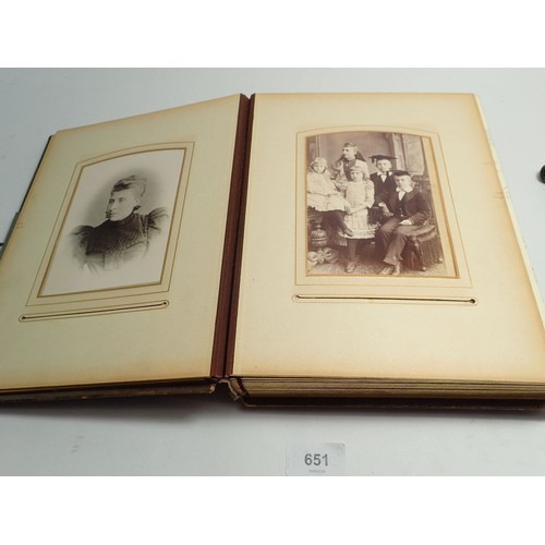 651 - A Victorian photograph album and contents of carte de visite portraits