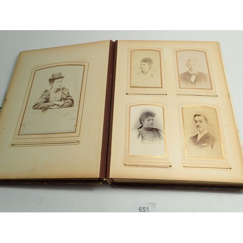 651 - A Victorian photograph album and contents of carte de visite portraits