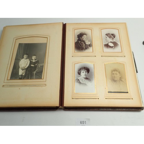 651 - A Victorian photograph album and contents of carte de visite portraits