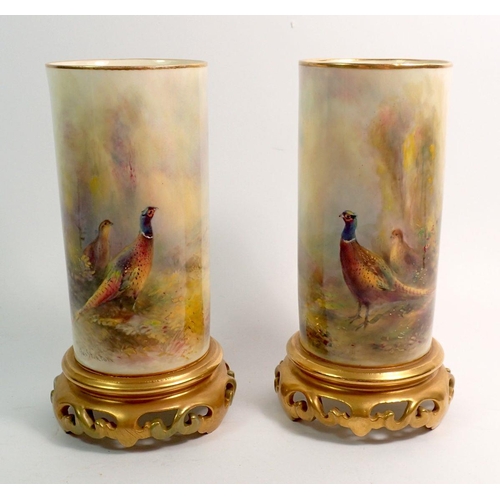 120 - Two Royal Worcester spill vases painted pheasants by Jas Stinton, 16cm - very minor gilding variatio... 