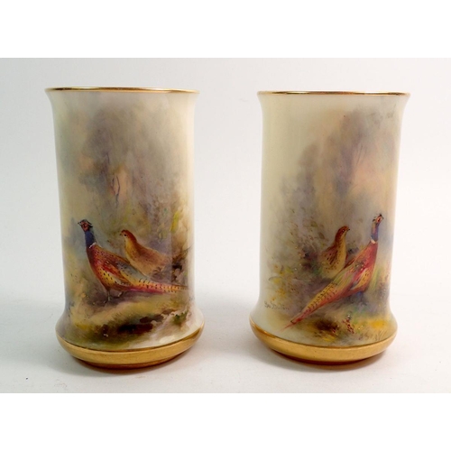 121 - A Royal Worcester pair of spill vases painted pheasants by Jas Stinton, 10.5cm, No 2510