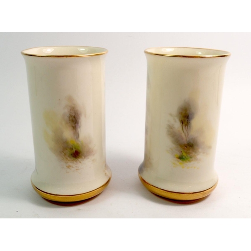 121 - A Royal Worcester pair of spill vases painted pheasants by Jas Stinton, 10.5cm, No 2510