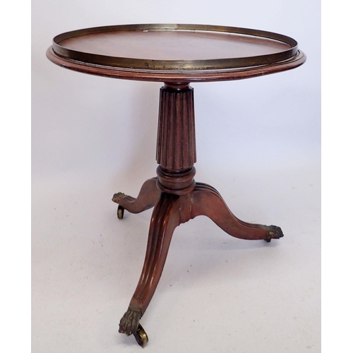 1256 - A 19th century mahogany circular occasional table with brass bound rotating top, all on reeded colum... 