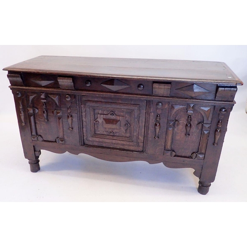 1257 - An early 20th century carved and panelled oak coffer in 17th century style, 131 x 48cm