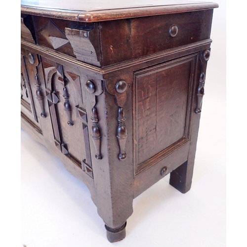 1257 - An early 20th century carved and panelled oak coffer in 17th century style, 131 x 48cm