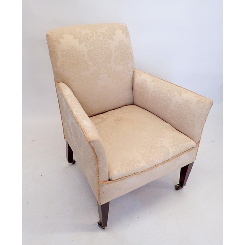 1266 - An Edwardian upholstered tub chair on tapered supports