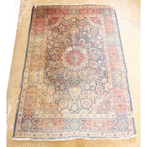 1285 - An antique Persian rug with floral medallion on a blue ground, 195 x 137cm