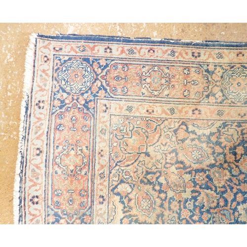 1285 - An antique Persian rug with floral medallion on a blue ground, 195 x 137cm