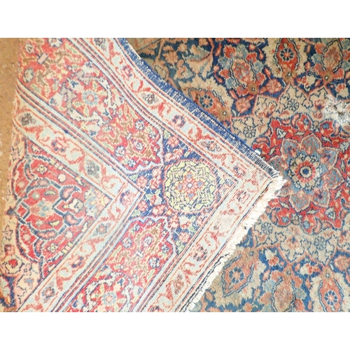 1285 - An antique Persian rug with floral medallion on a blue ground, 195 x 137cm