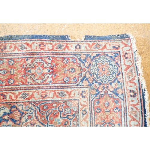 1285 - An antique Persian rug with floral medallion on a blue ground, 195 x 137cm